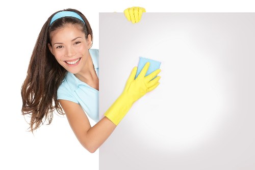 Technician wearing PPE while cleaning a carpeted floor